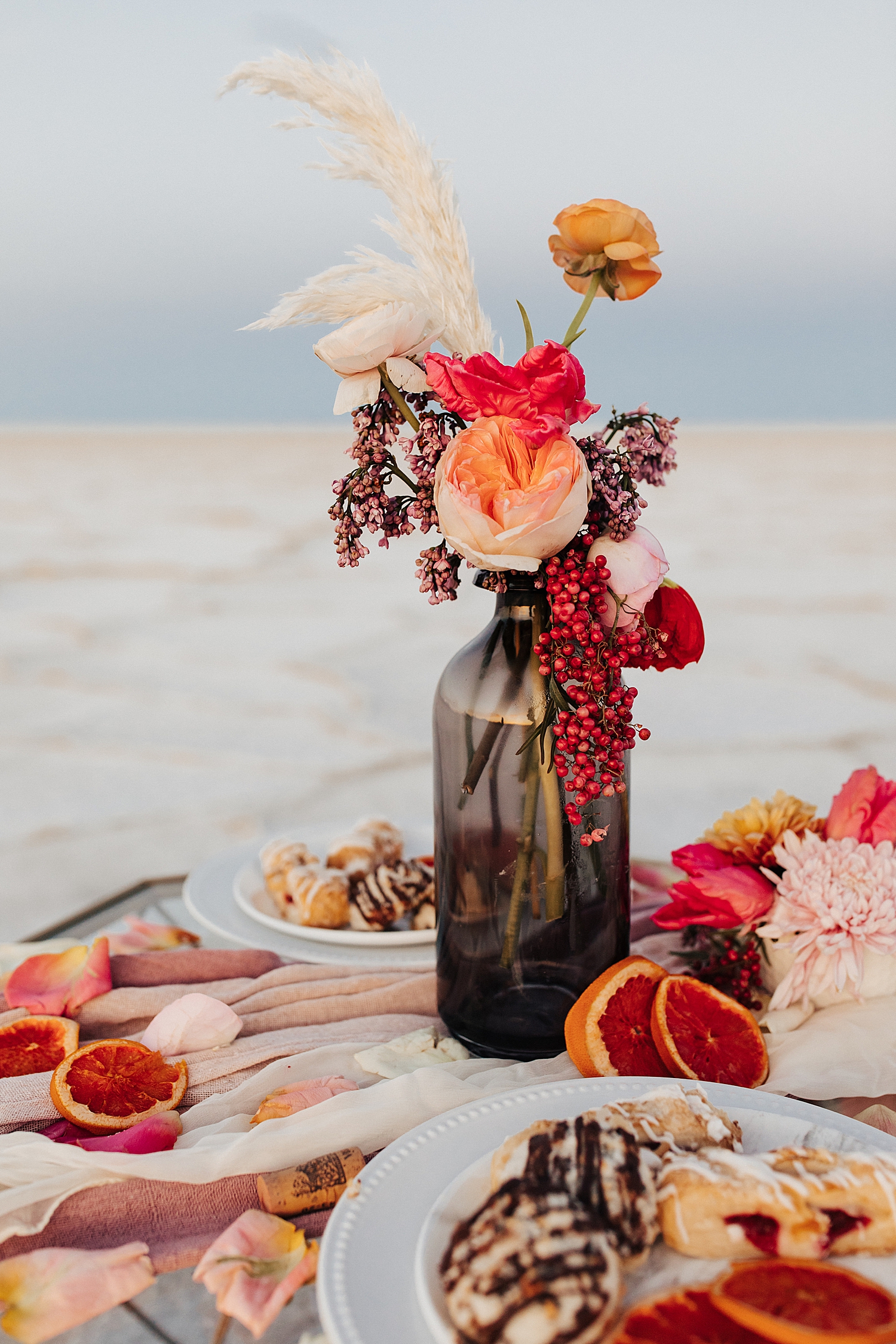orange and pink flowers in vase for picnic for styled session with sweet afton floral