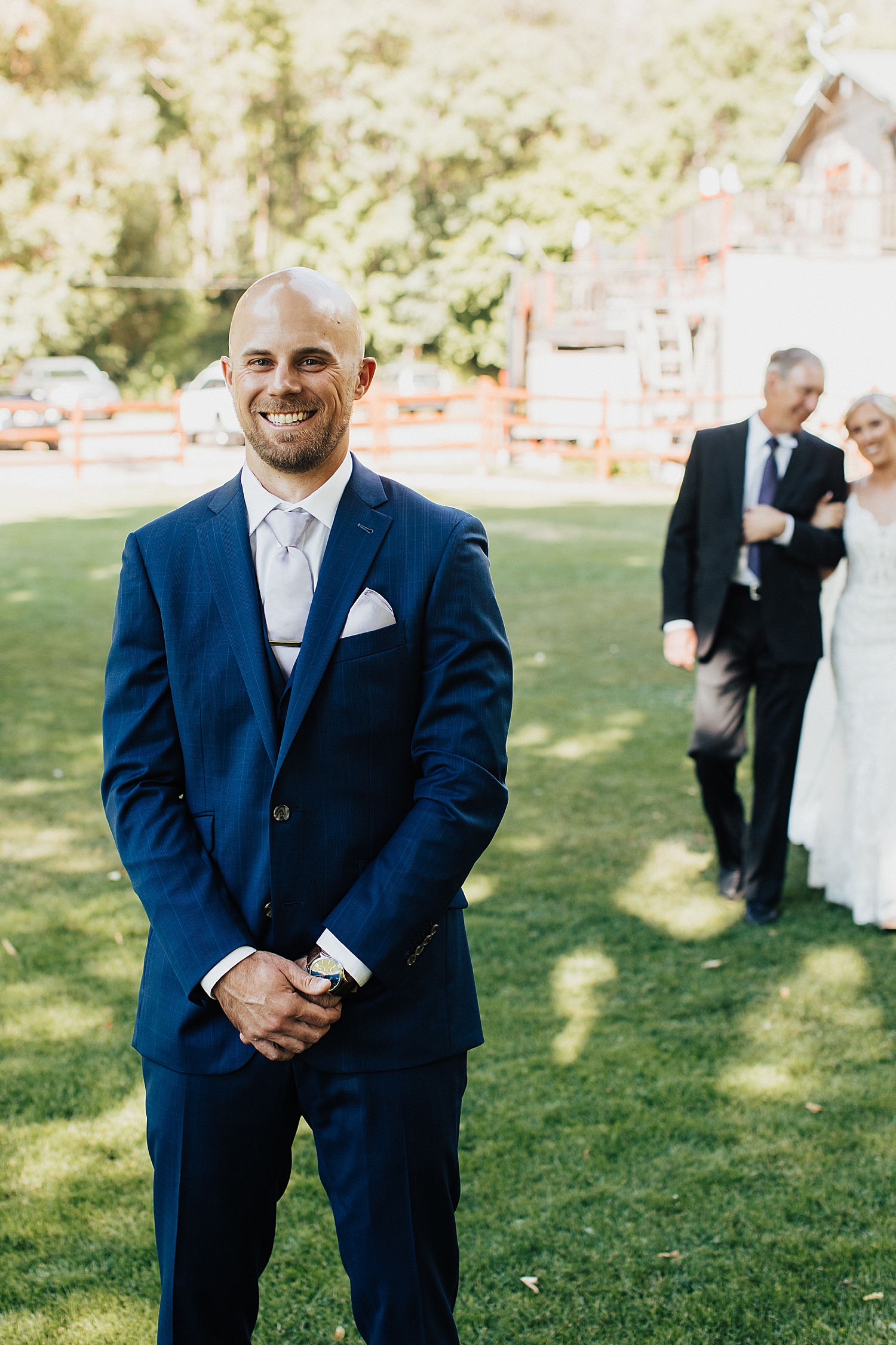 groom waits while bride and father walk up to him for first look by Nicole Aston Photography