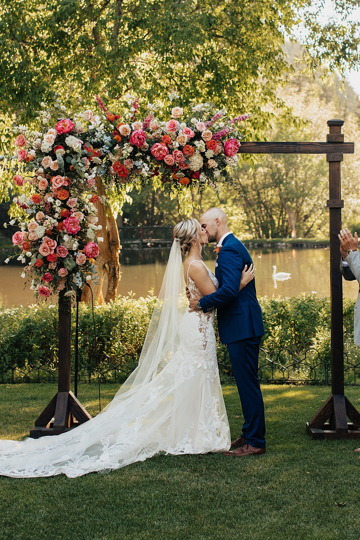 husband and wife share a first kiss at ceremony by Nicole Aston Photography