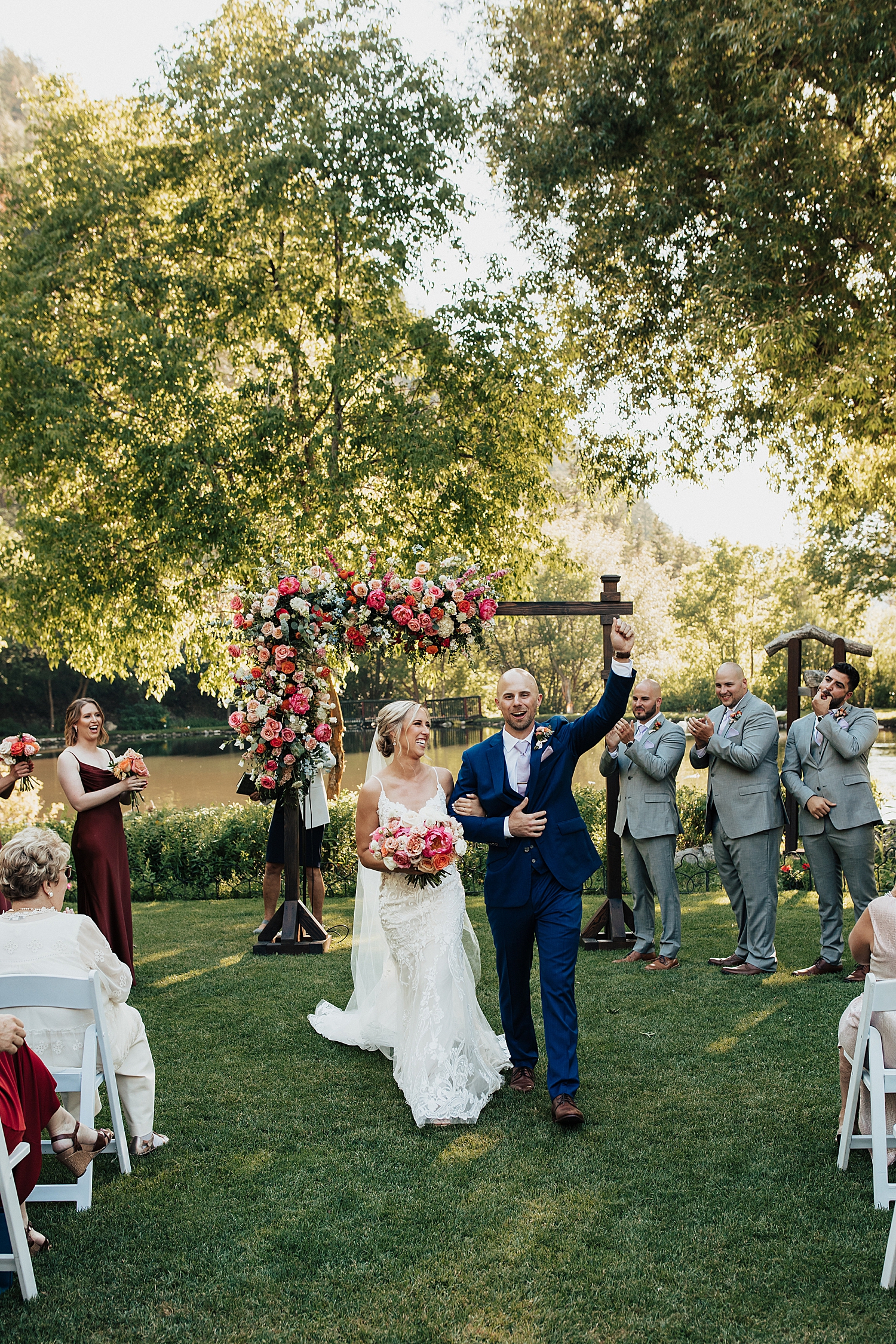 groom fist bumps air after ceremony at at Log Haven Venue in Utah