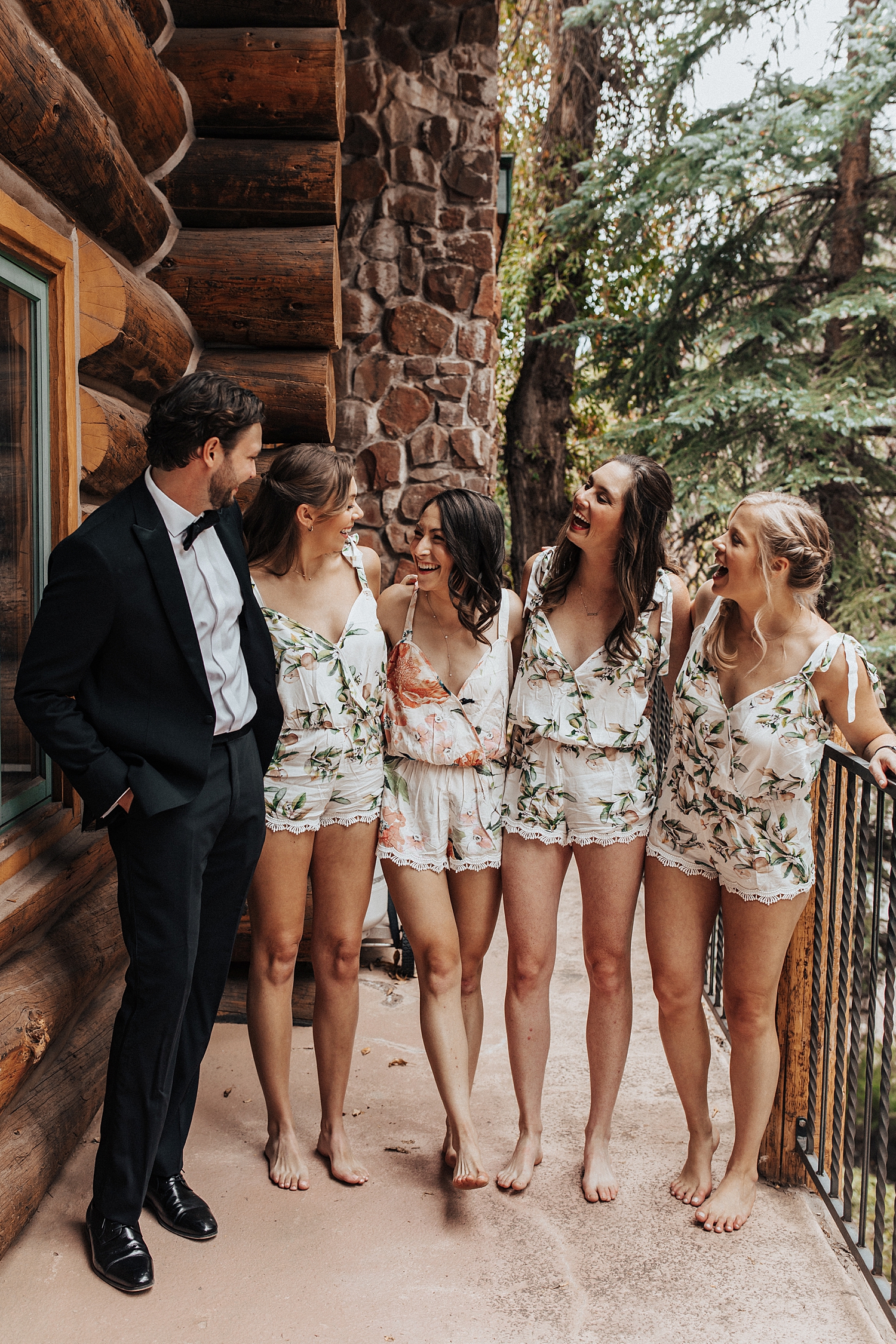 bridesmaids surround bride on porch for summer wedding in aspen