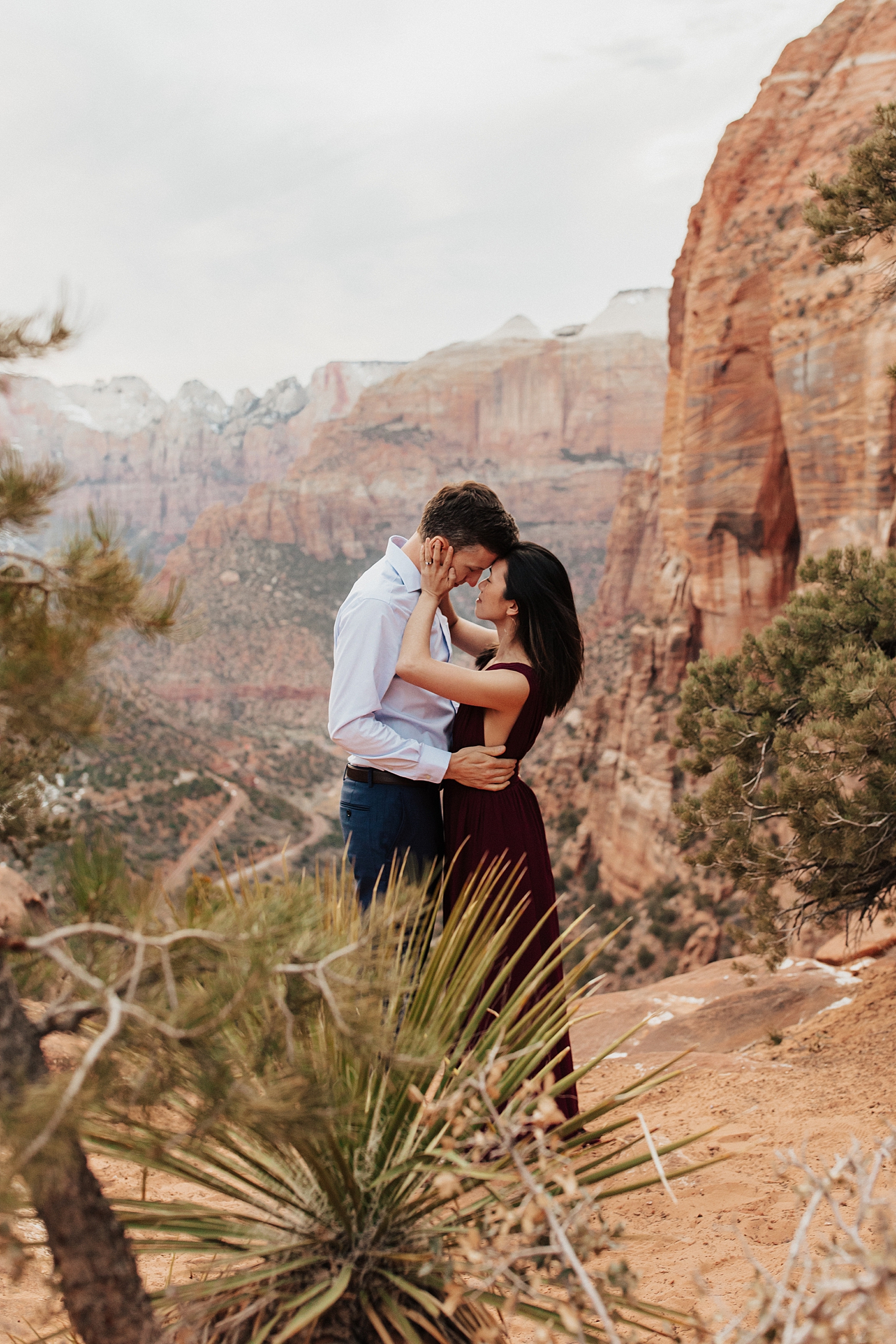 couple embraces closely in front of rugged mountain backdrop by Destination wedding photographer