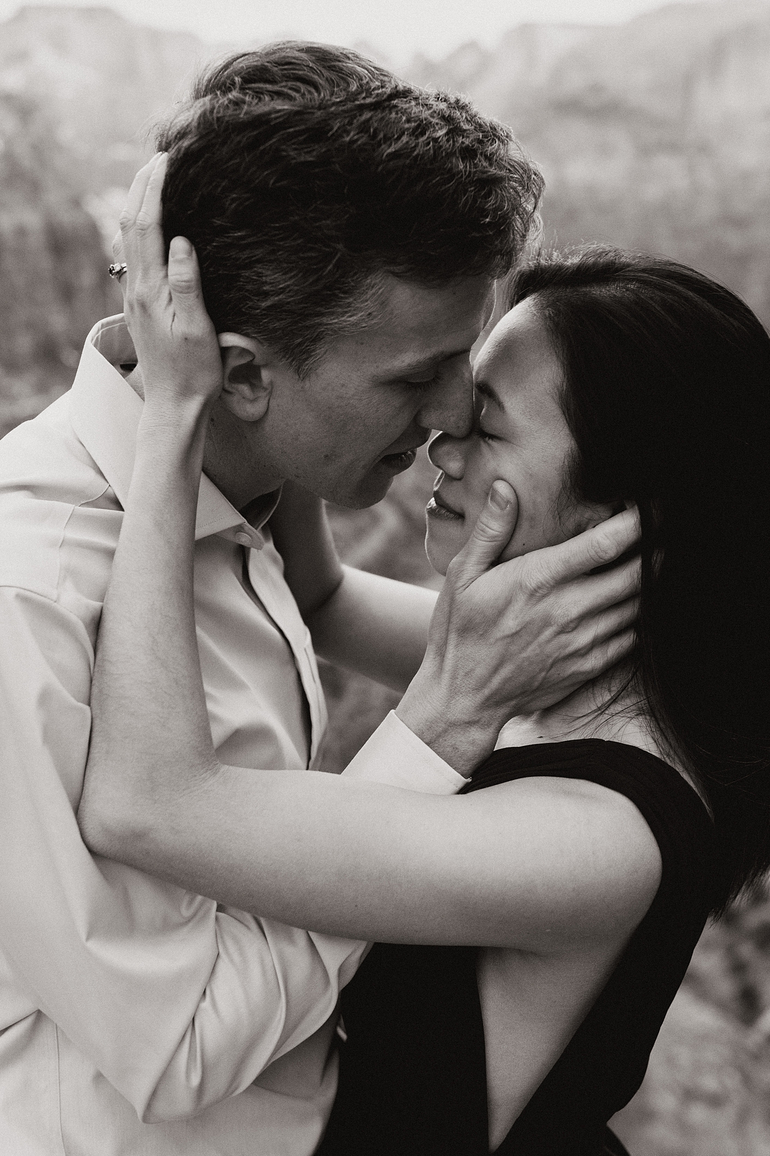 couple hold each other's faces closely for engagement session by Nicole Aston Photography