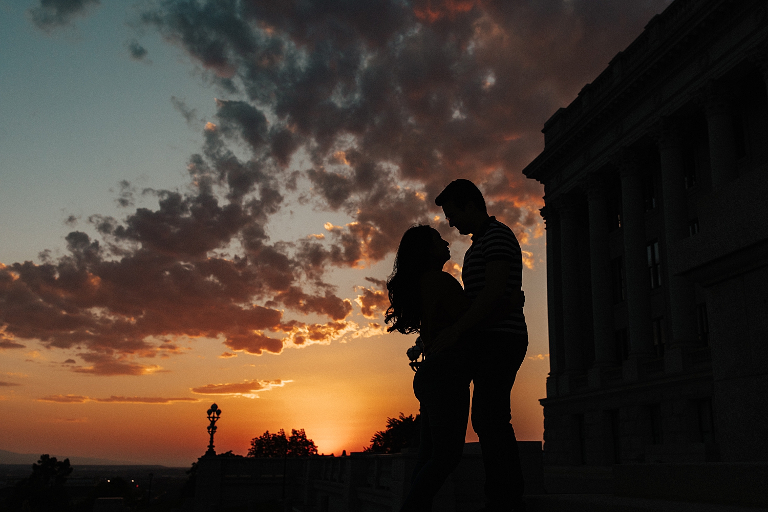two people silhouetted against a sunset for Capitol Building engagement session