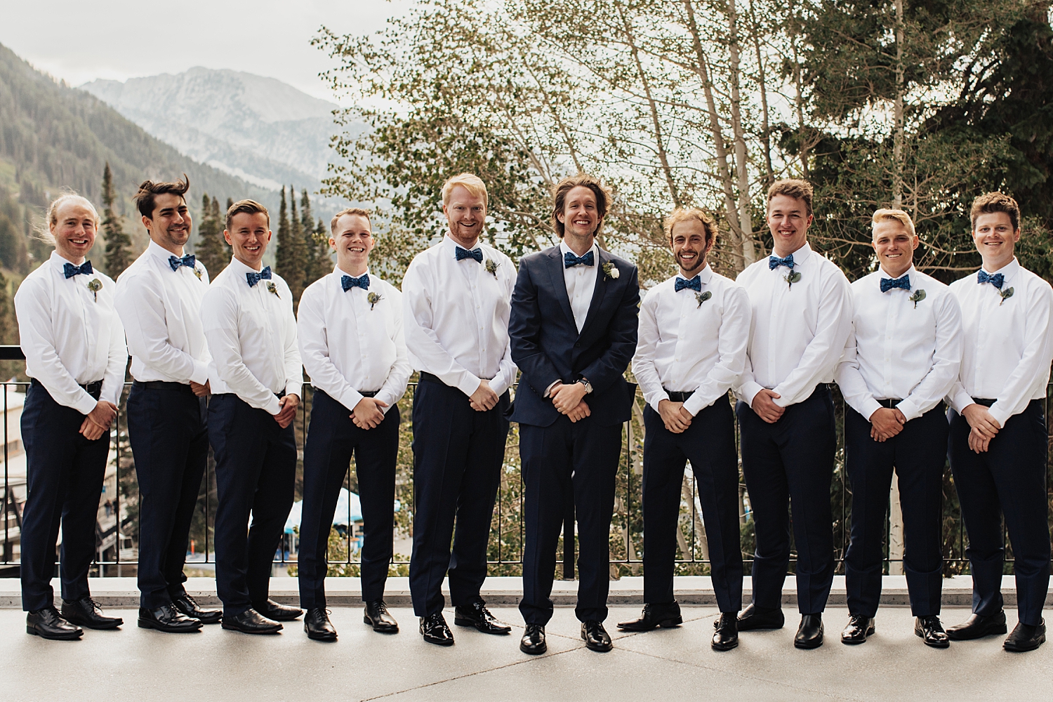 groomsmen surround their friend on patio by Nicole Aston Photography