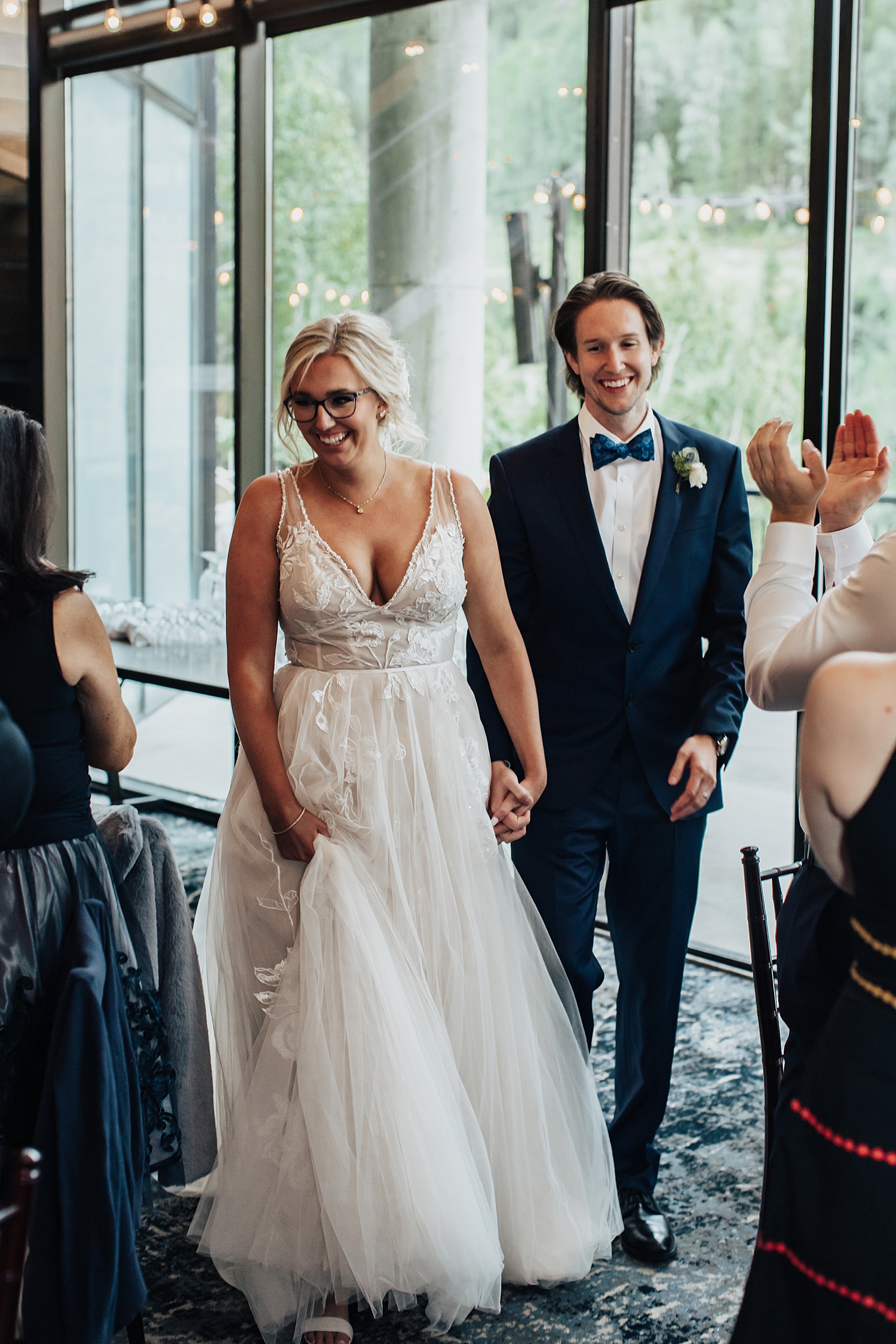 newlyweds enter their reception hand in hand by Destination wedding photographer