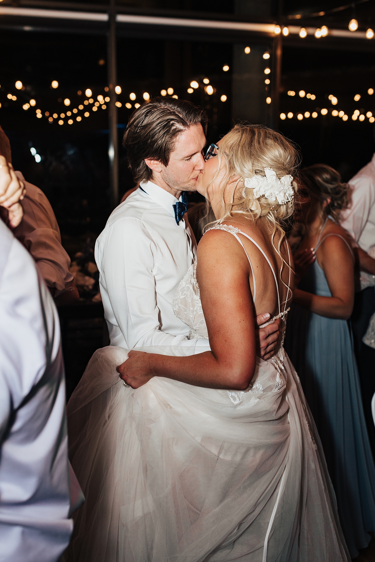 husband and wife share a kiss on dance floor at reception by Destination wedding photographer