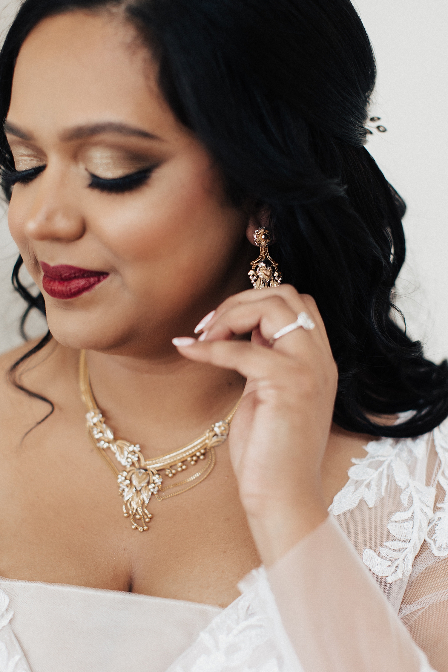 bride adjusts her earring before ceremony at Pomme Radnor