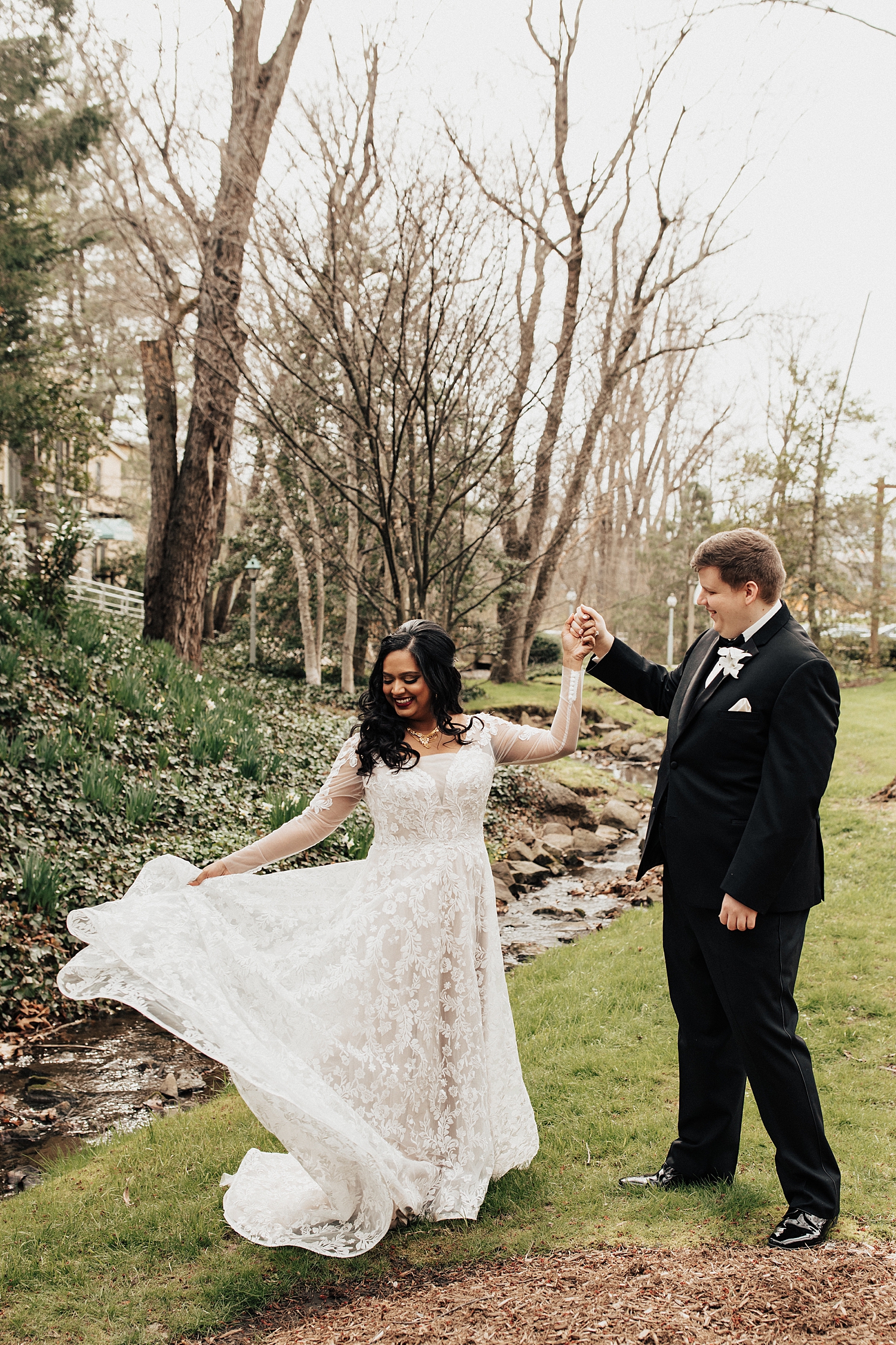 man spins his bride on lawn at Pomme Radnor