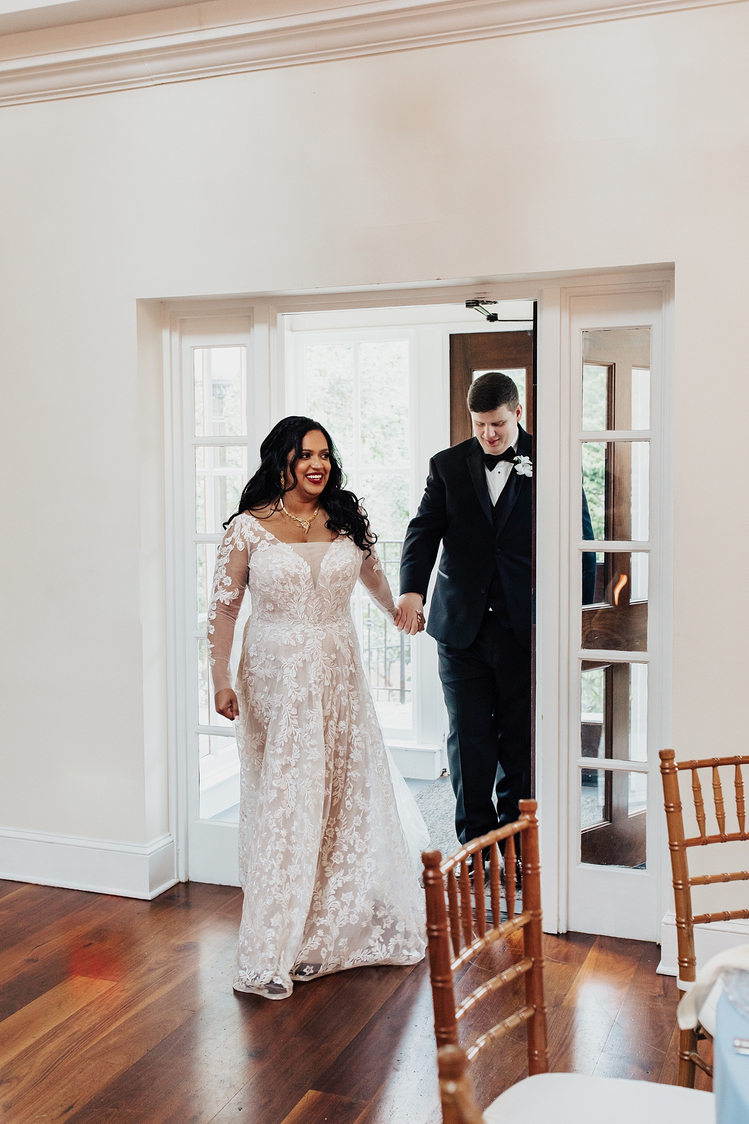 newlyweds enter their reception by Destination wedding photographer