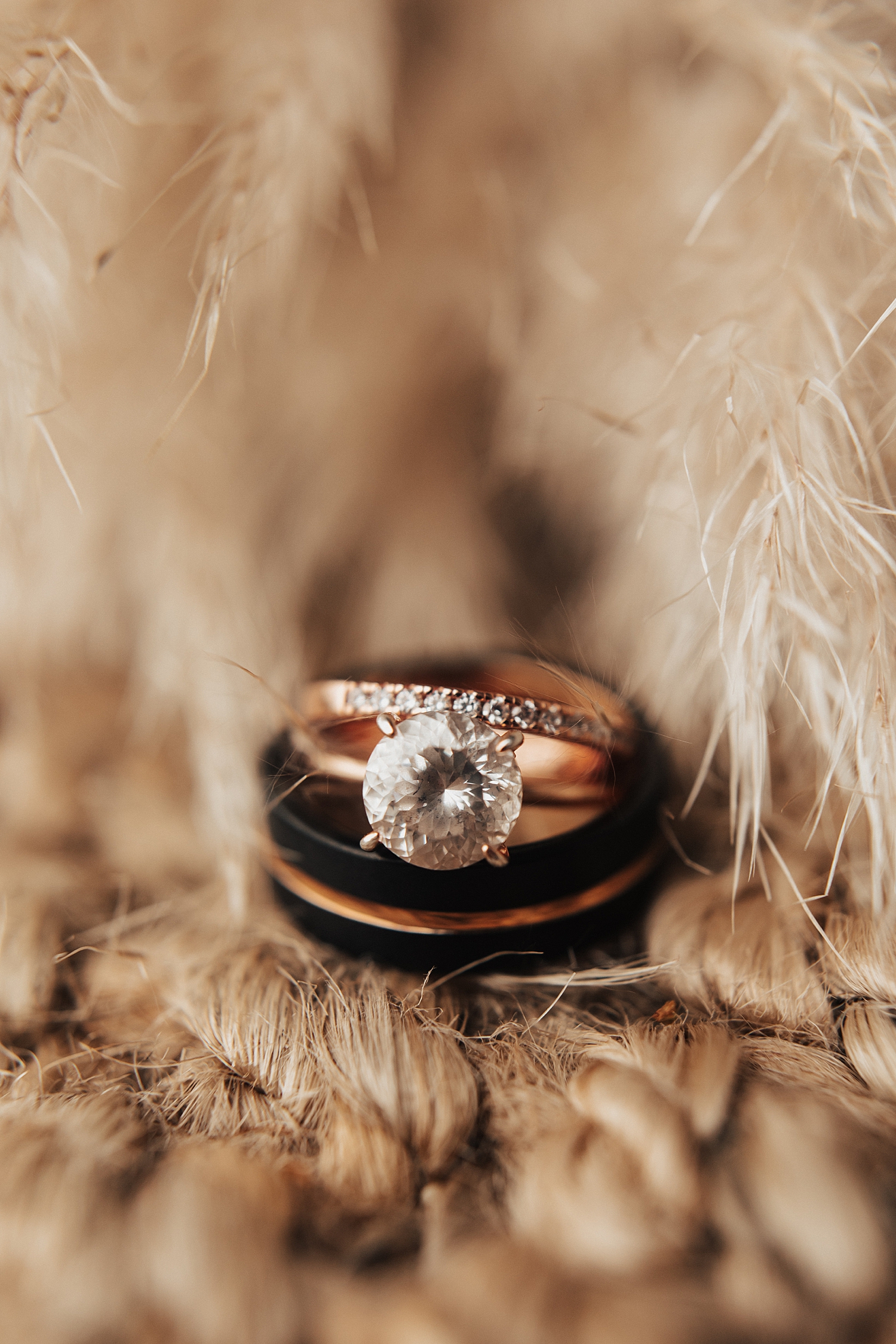 diamond rings in textured backdrop for Iowa wedding weekend