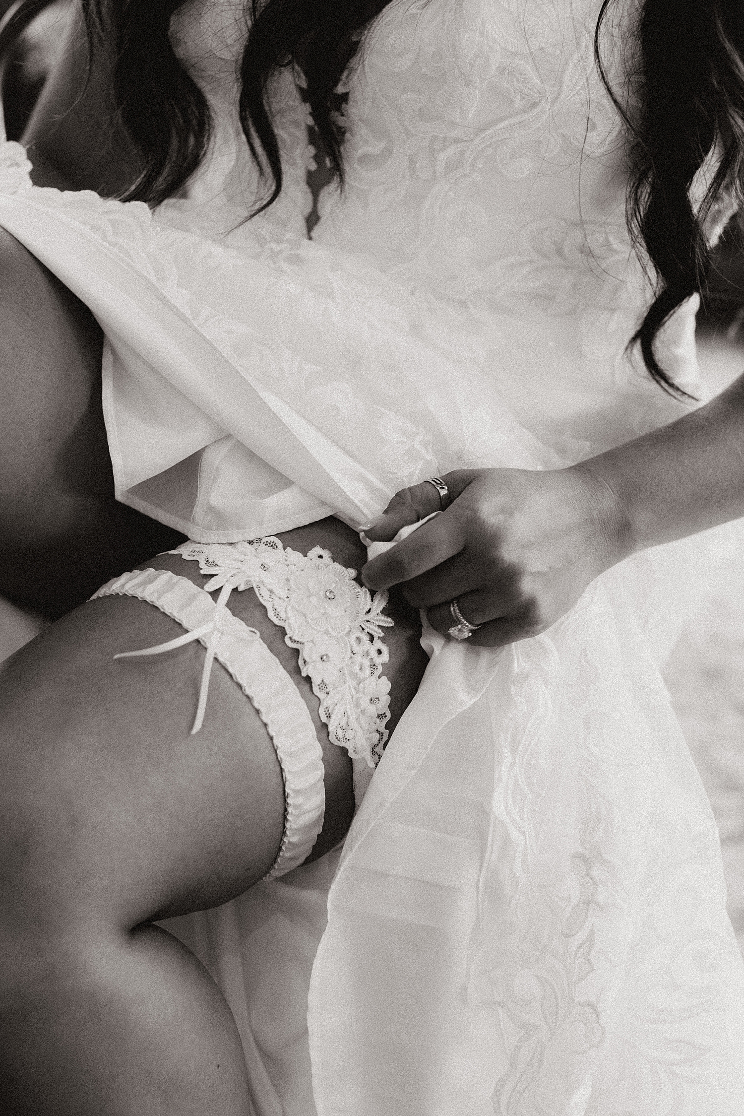 bride shows off her garter by Destination elopement photographer