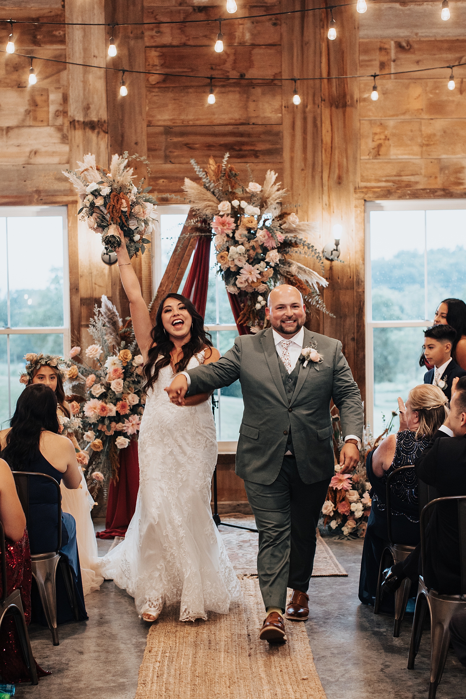 man and woman celebrate back down the aisle by Destination elopement photographer