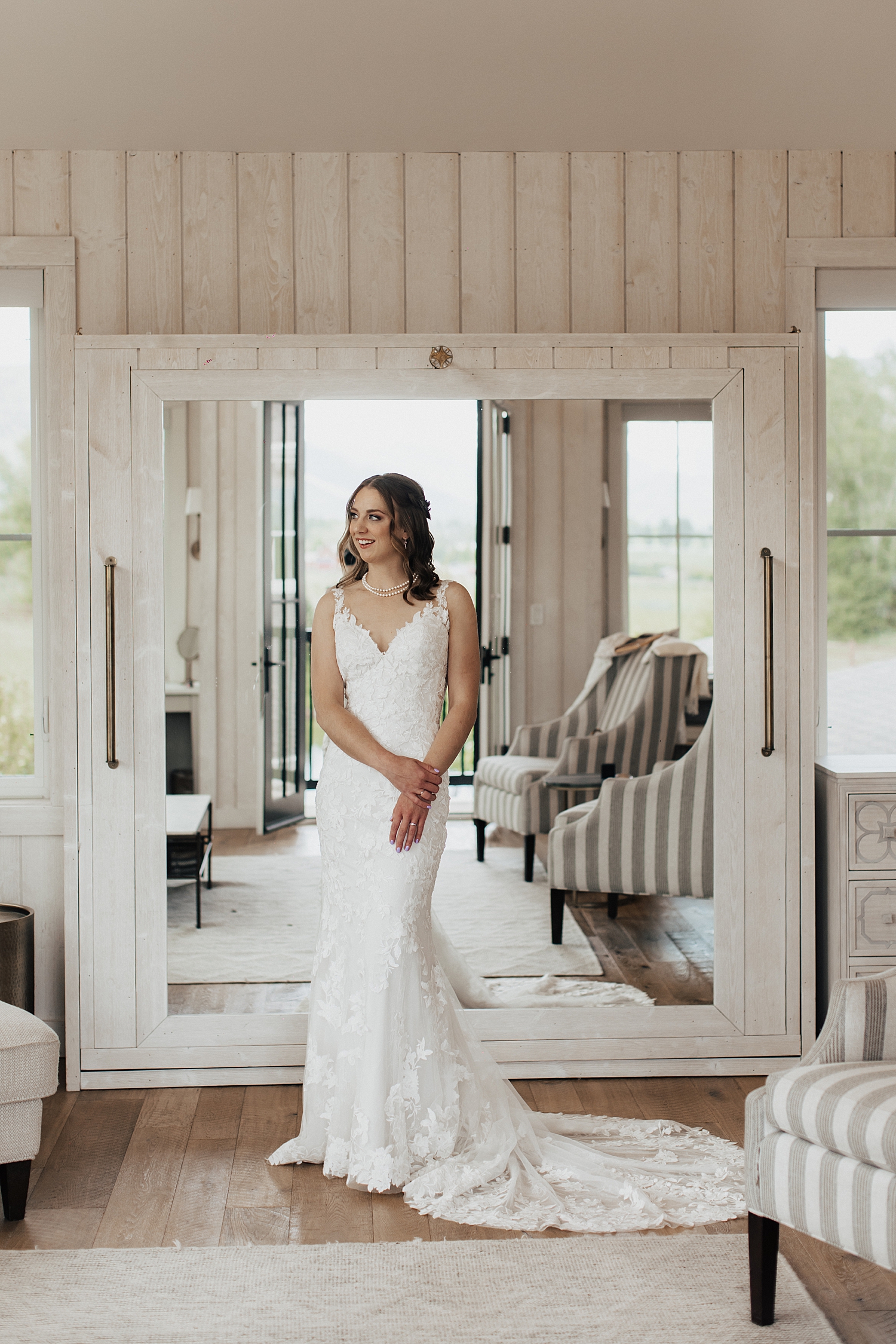 bride in getting ready room with white walls by Destination wedding photographer