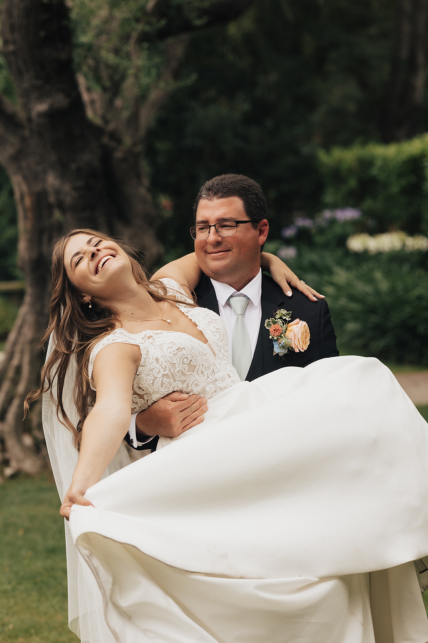 groom spins bride in garden by Destination elopement photographer