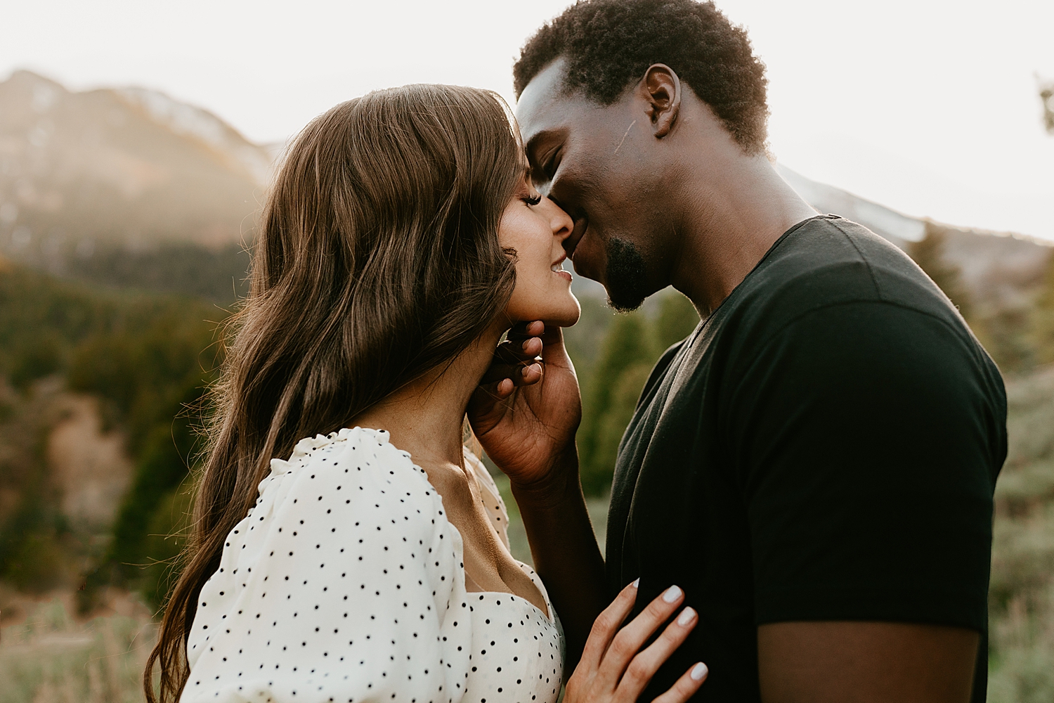 man leans in to softly kiss his woman at Tibble Fork