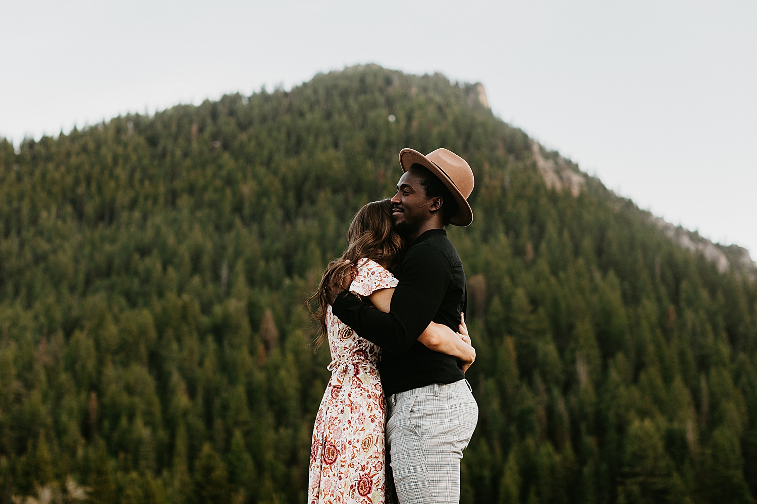 man hugs his fiance closely by destination wedding photographer
