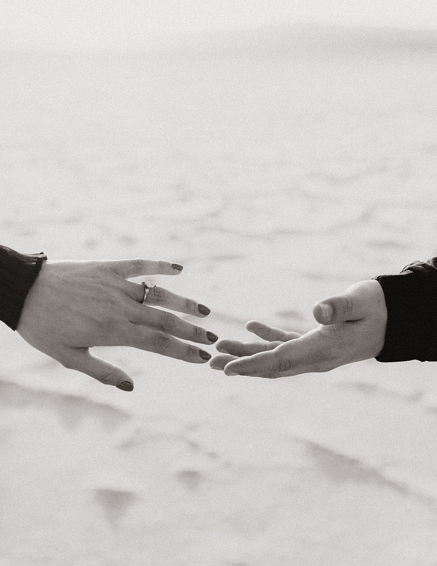 hands reaching across desert space by Nicole Aston Photography