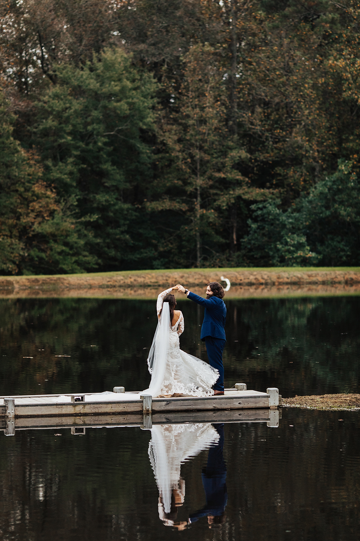 man spins his new bride on dock at Southern Backyard Wedding
