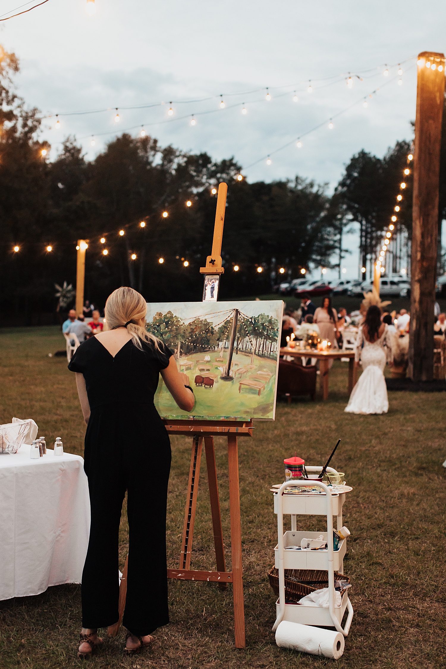painter live paints during outdoor wedding reception by Nicole Aston Photography