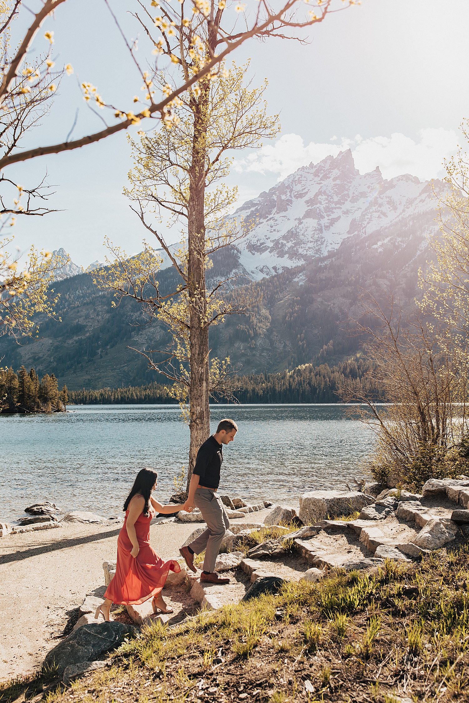 man leads woman up stone steps at Grand Tetons National Park