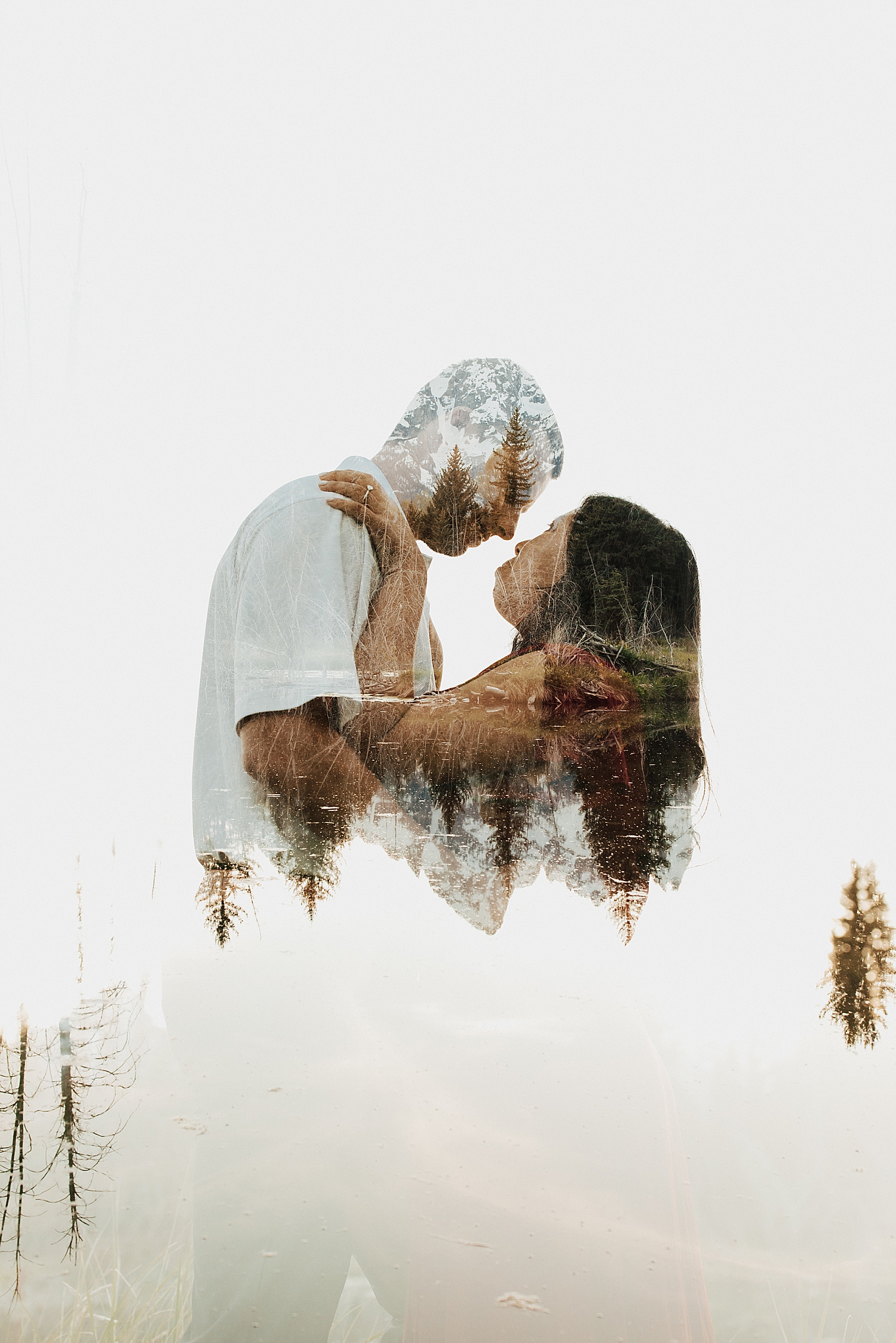 engaged couple lean in for a kiss in front of mountains by Destination Wedding Photographer